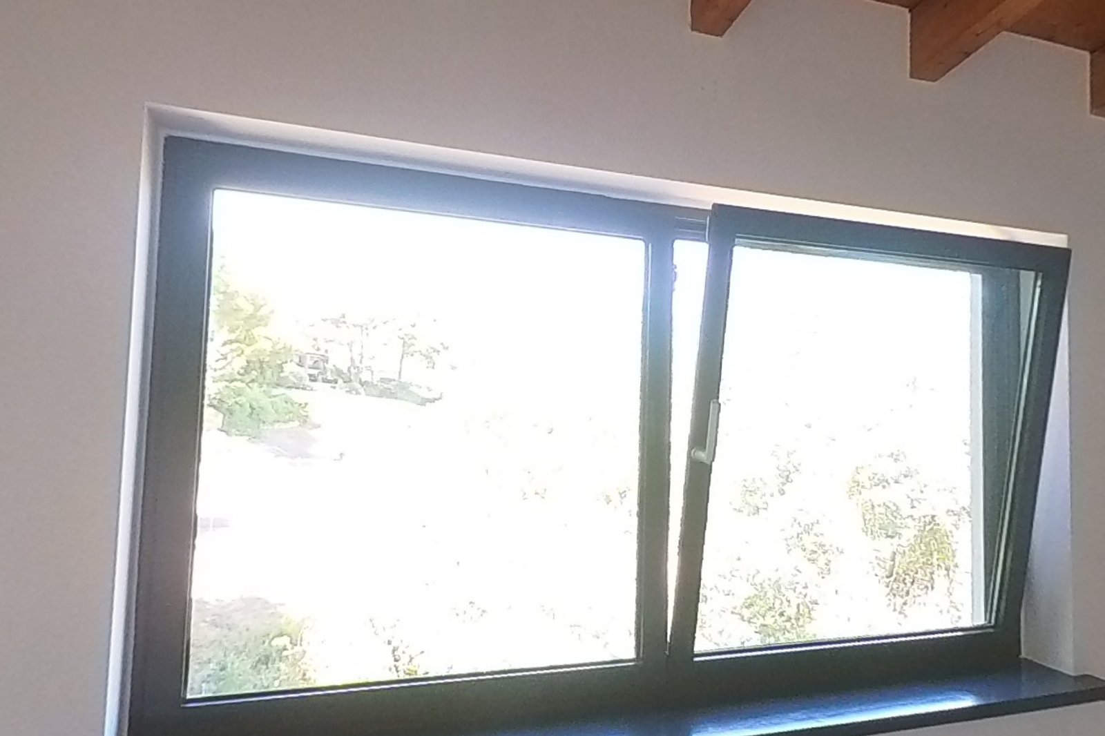 Dormitorio con vigas de madera laminada vista